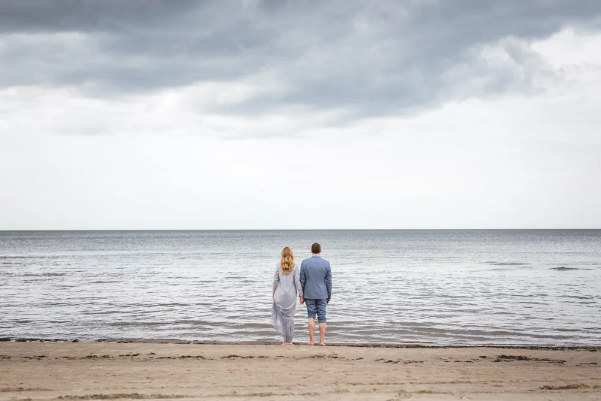 VioletDates Review - harmonious couple looking at the sea holding hands