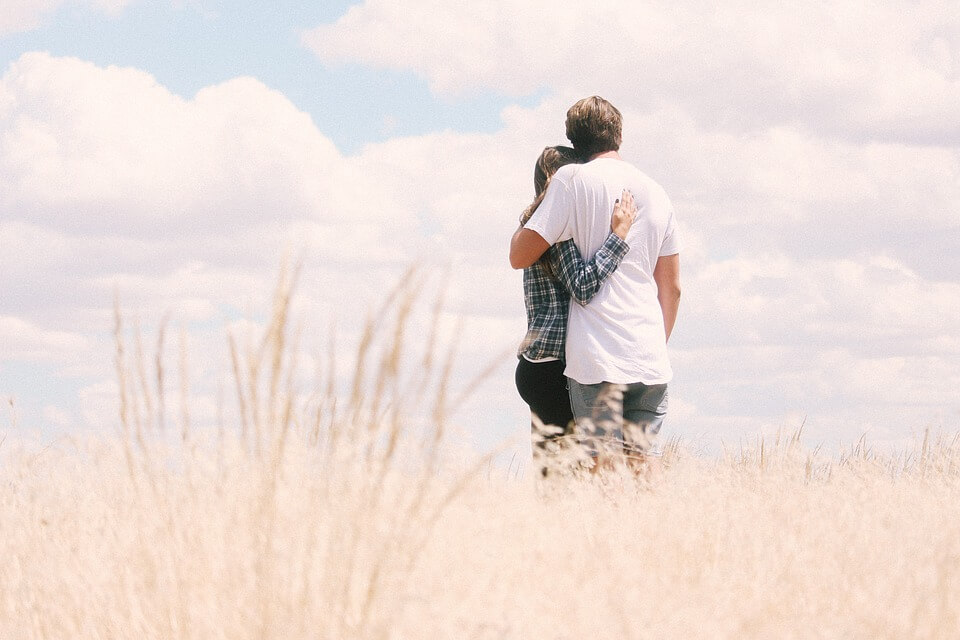 A couple in love embracing in a wheat field