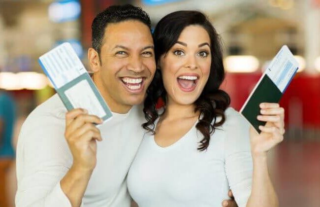 a couple is happy with plane tickets