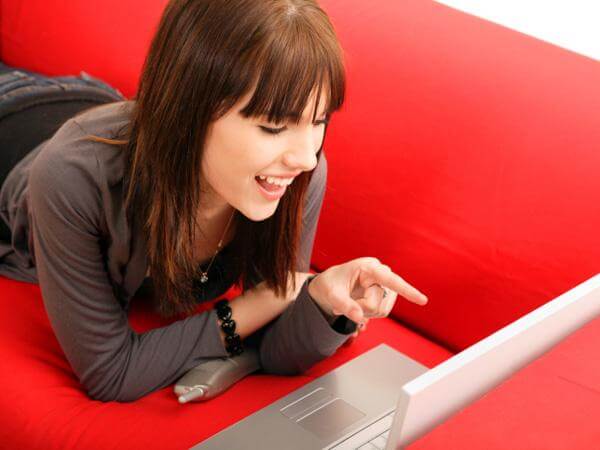A girl communicates via video call on her laptop