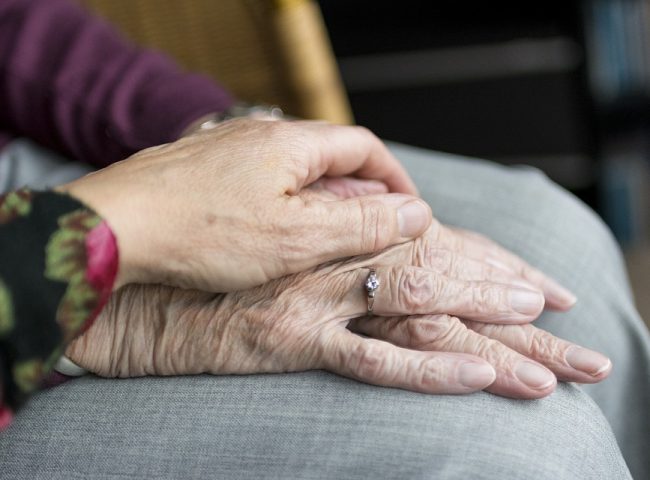 A pair of hands of two married elderly people