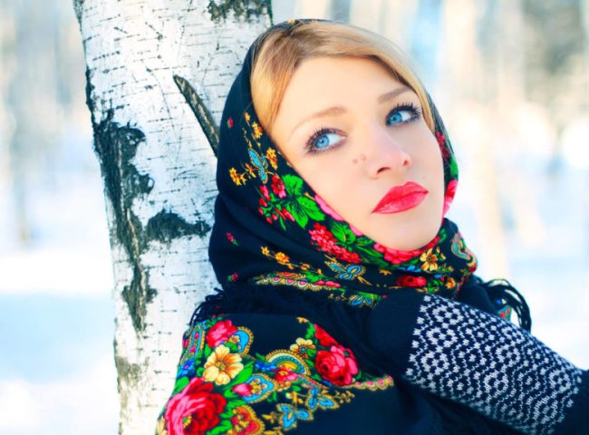 A Russian woman in the birch forest in winter