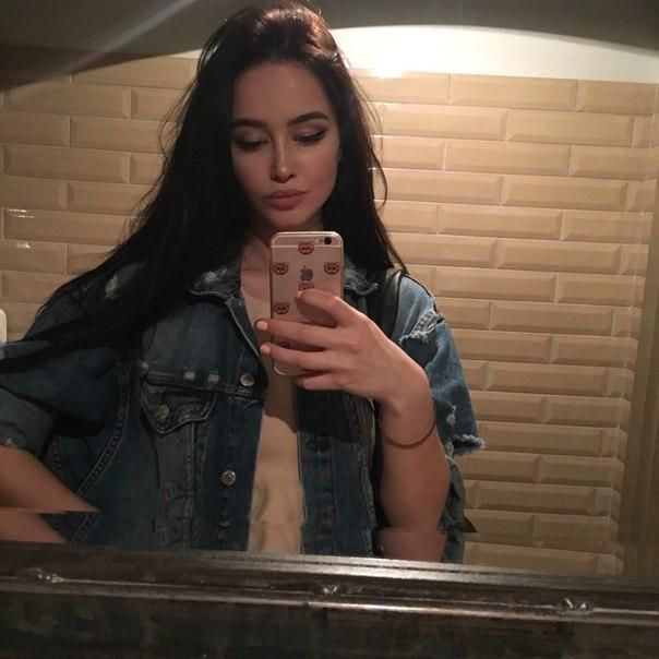 A young girl is photographed in a cool restaurant restroom