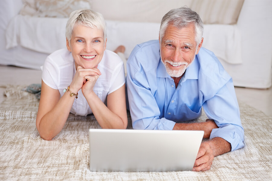An age-loving couple watching together with a laptop