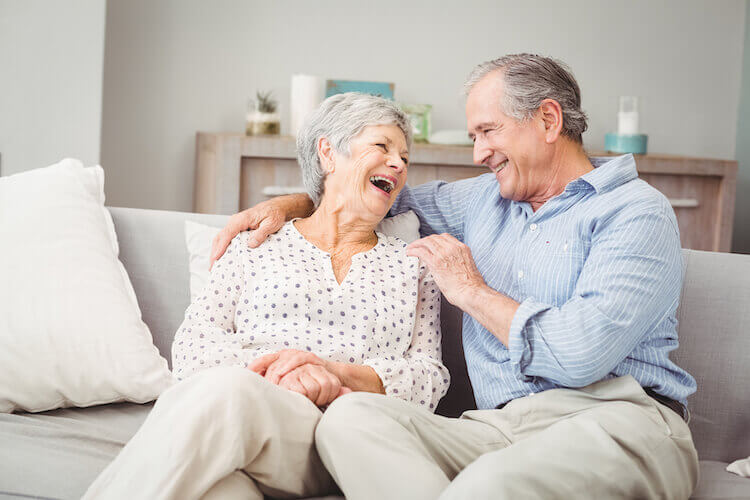 An age old couple in love laughing together