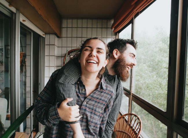 beautiful hipster couple smiling on the balcony