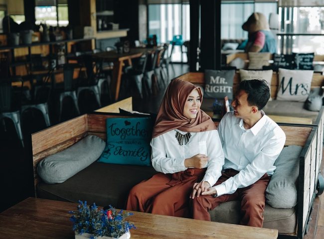 Muslim couple holding hands in a restaurant