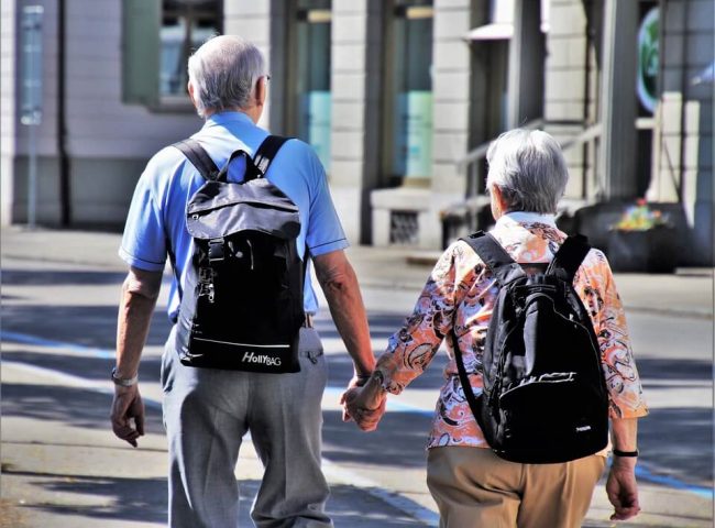 two old people walking hand in hand