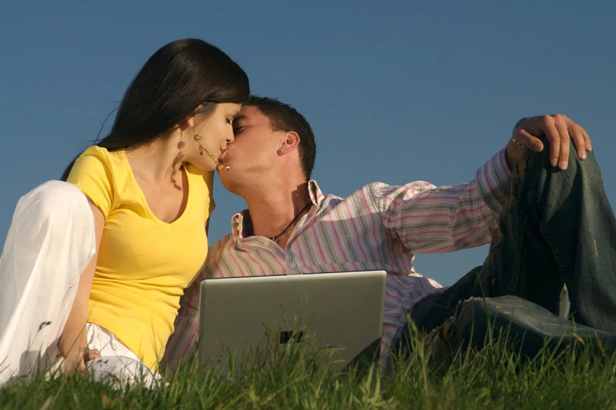 MySensualMatch - guy and girl sitting on the lawn and kissing